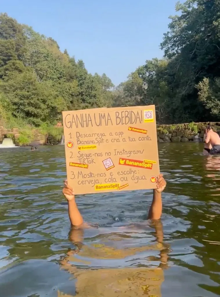 Leo in the Vilar de Mouros river holding the BananaSplit campaign sign