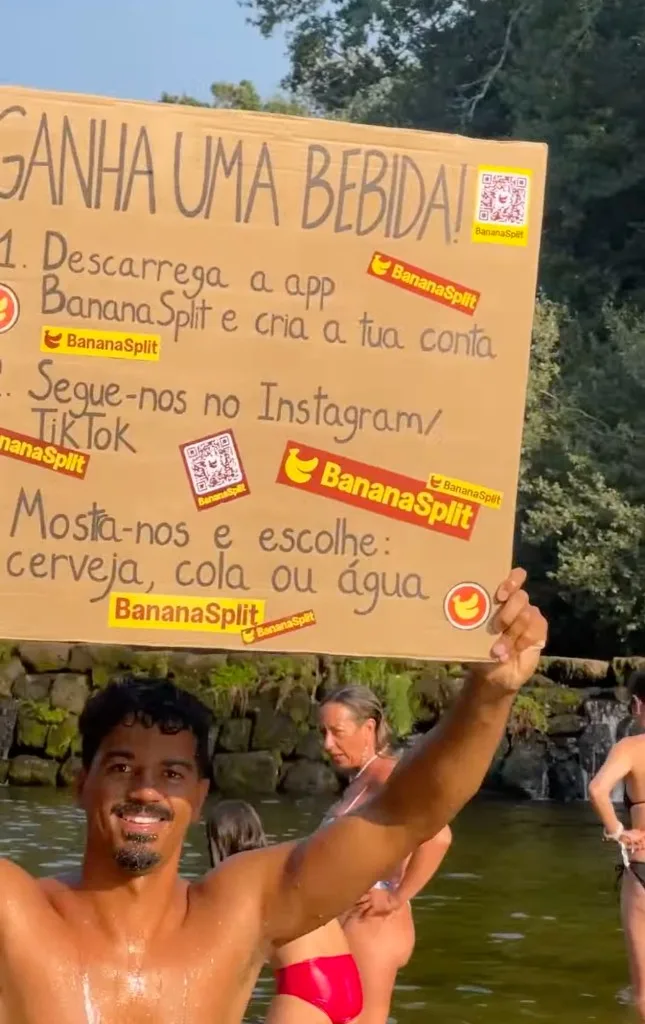 Leo in the Vilar de Mouros river holding the BananaSplit campaign sign