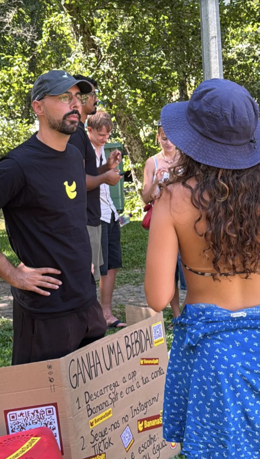 Diogo presenting the BananaSplit campaign beside the handmade sign
