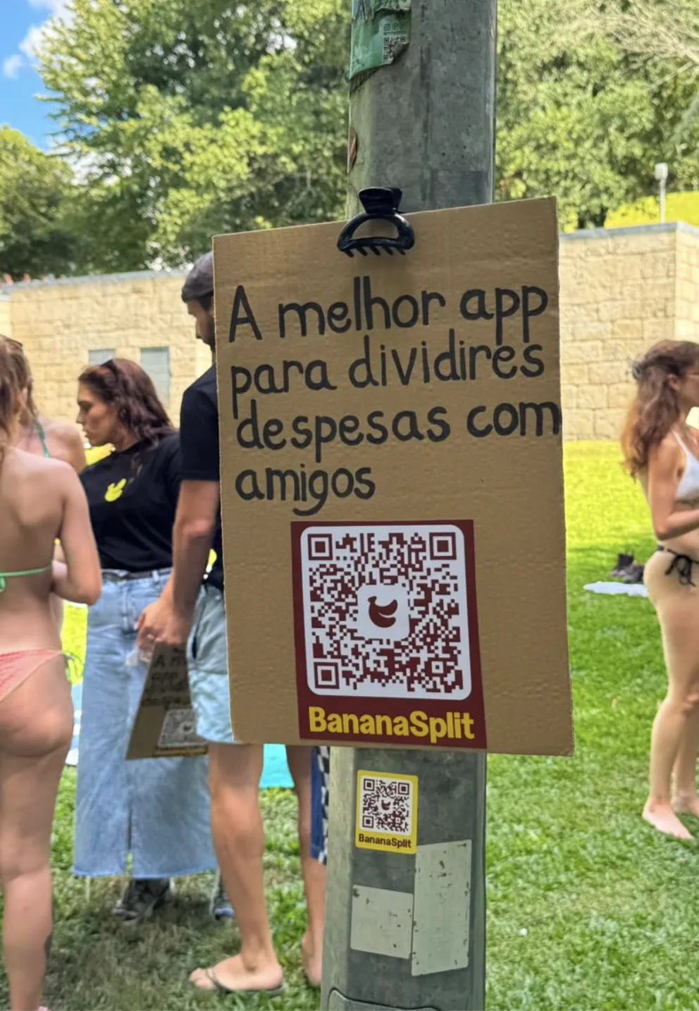 BananaSplit cardboard sign with a QR code for splitting expenses with friends