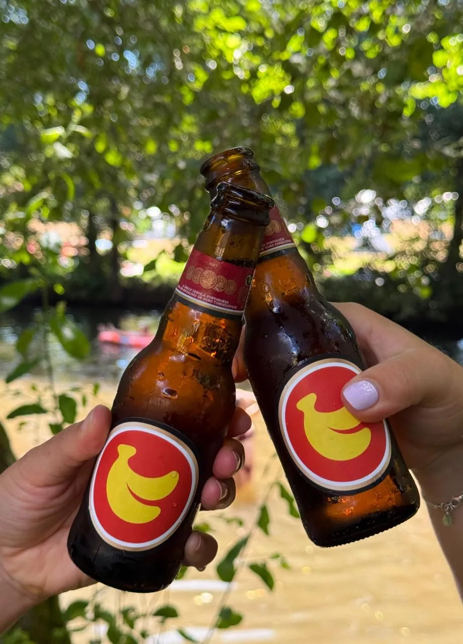 Two bottles of Super Banana Bock by the Paredes de Coura river