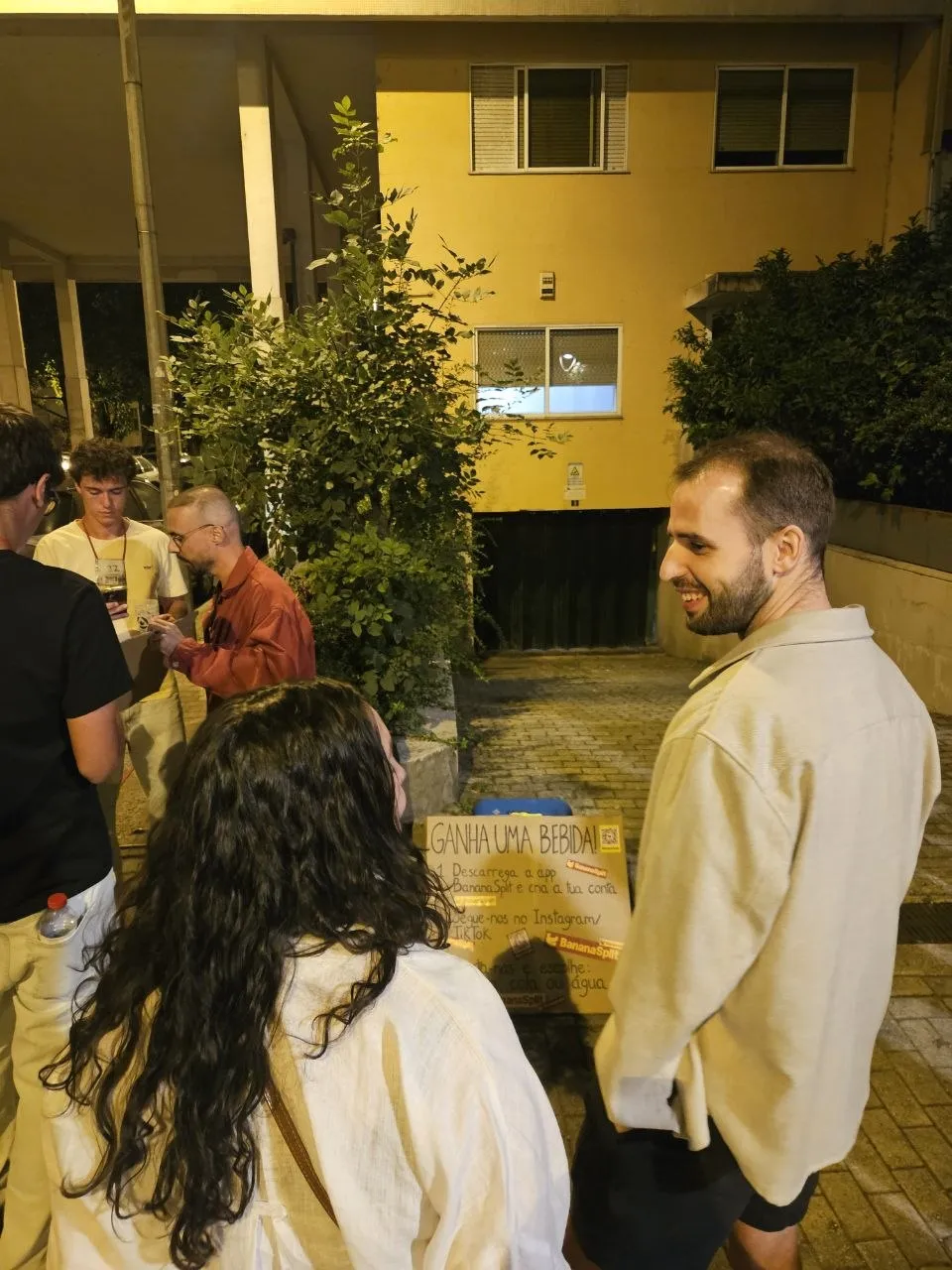 Ana y Henrique junto al cartel de BananaSplit, en la calle de noche