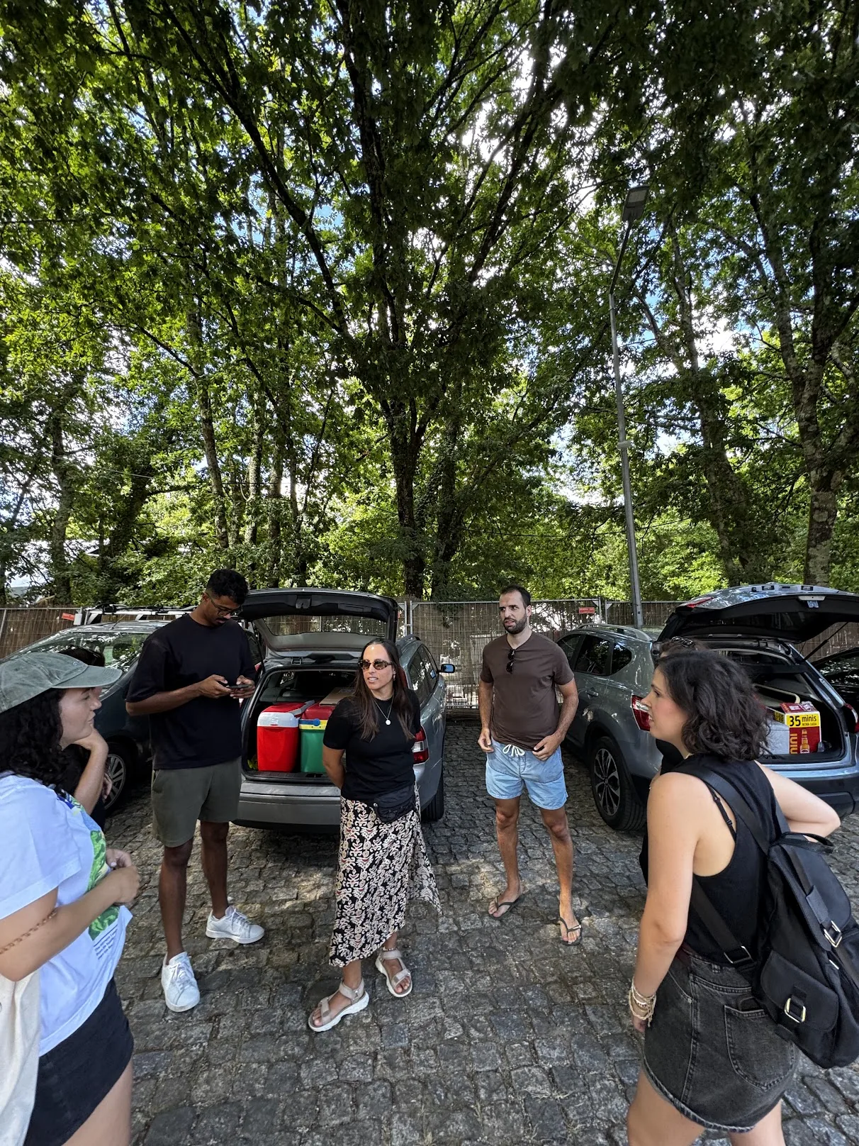 BananaSplit team organising campaign gear next to the cars