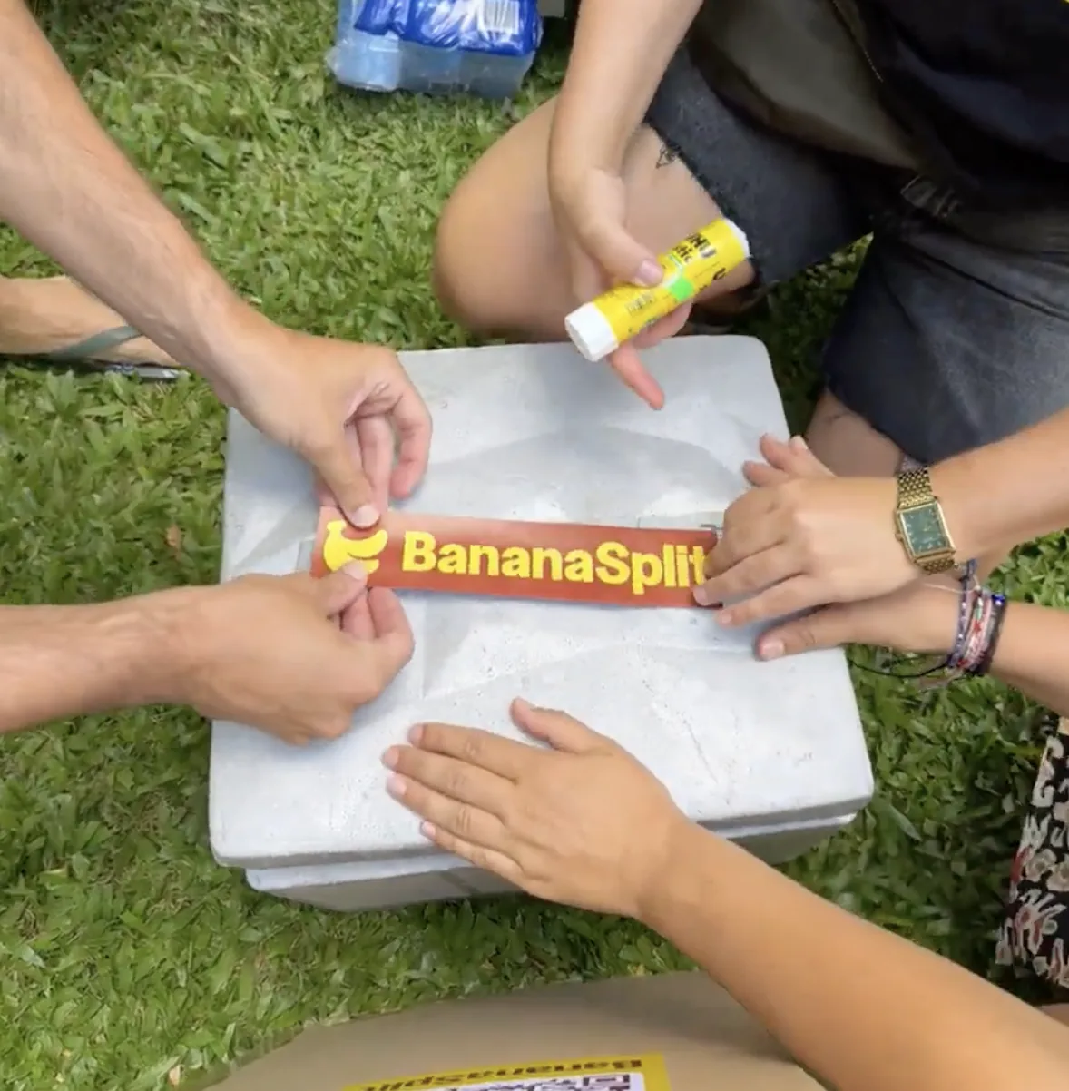 Team applying a BananaSplit sticker to a cooler